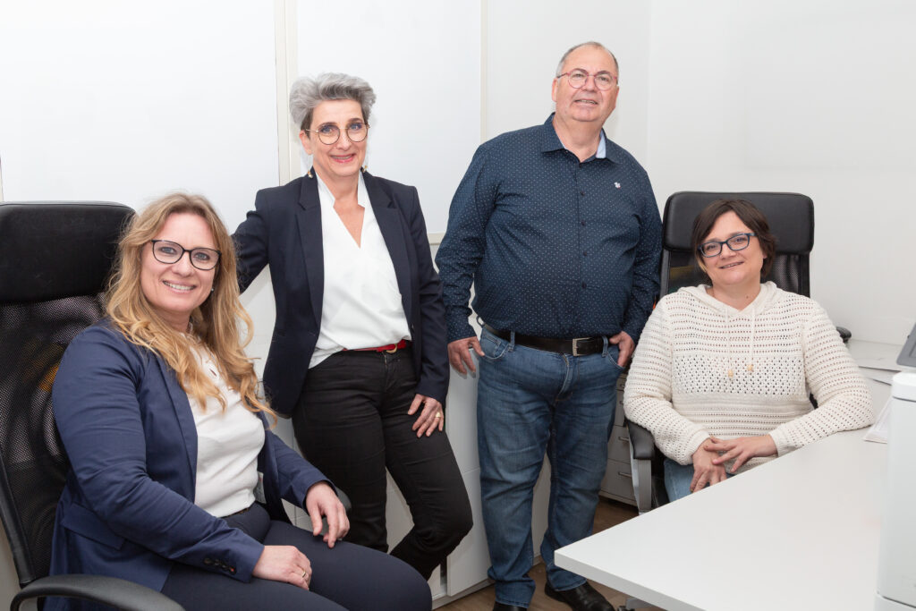 Ihre Steuerberatungskanzlei in der Steiermark – Auf dem Bild ist das Team der Kanzlei zu sehen: links Bilanzbuchhalterin Manuela Lunzer, links Mitte Sekretärin Eveline Podrepsek, rechts Mitte Steuerberater und Eigentümer Mag. Walter Gusel sowie rechts Bilanzbuchhalterin Nicole Ernst. Das Team lächelt freundlich in die Kamera und vermittelt eine sympathische, einladende Atmosphäre.